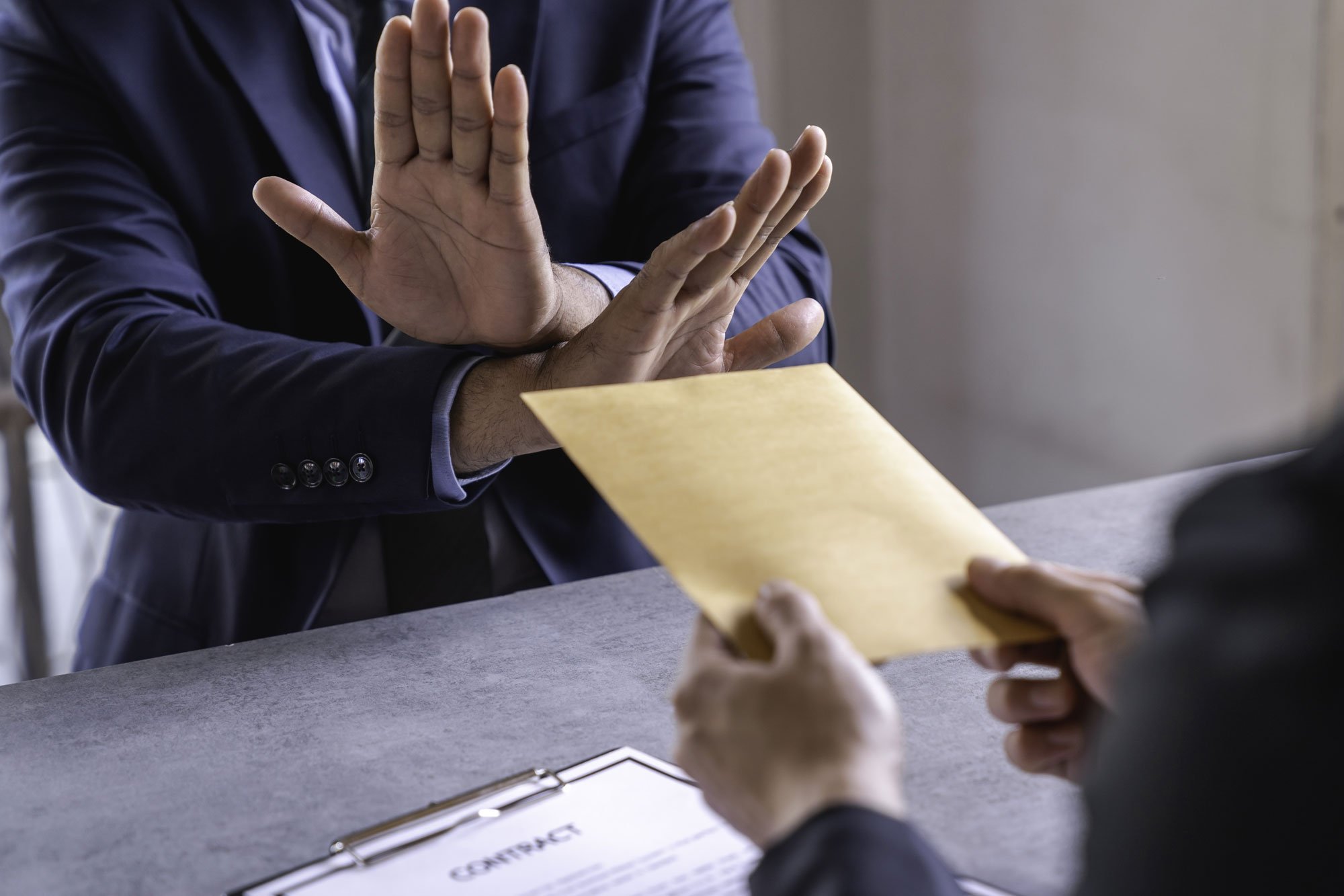 business-man-declining-envelope-of-money-at-desk-2026-03-19-01-52-49-utc